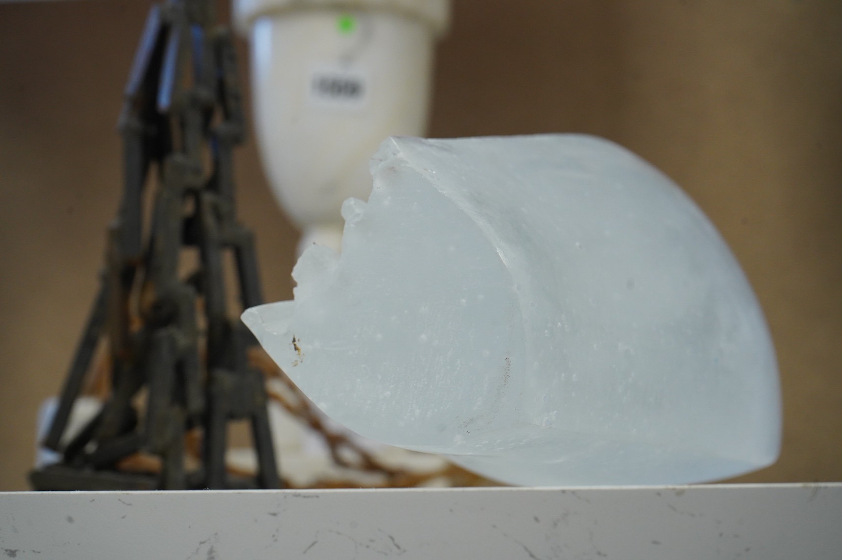 A contemporary Brutalist style glass and iron sculpture and two bronzes signed 'VA', 27cm